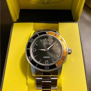 Silver Invicta wristwatch with a touch of black and bronze.